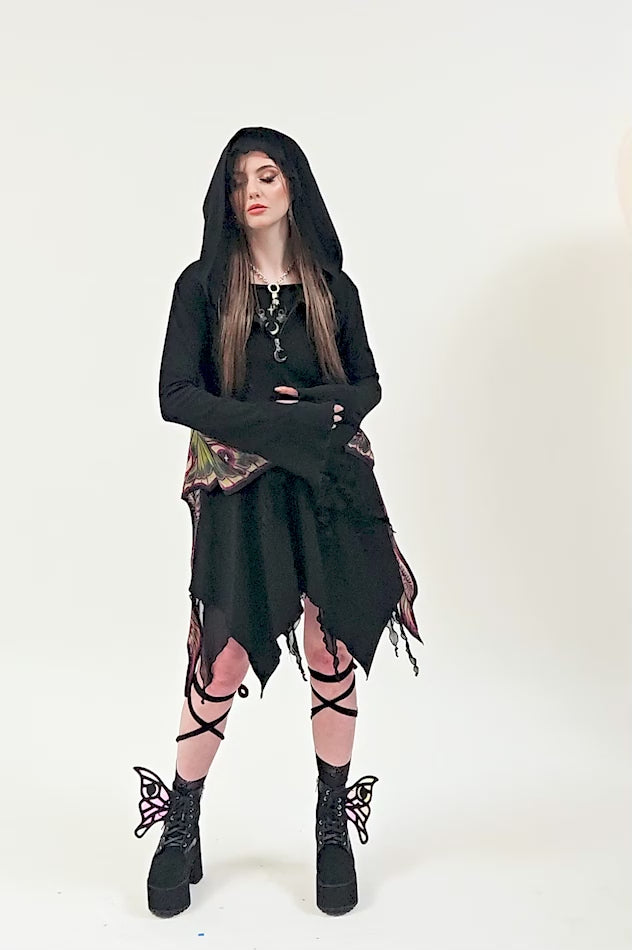 video of a dark cottagecore woman wearing a asymmetric hem dark fairycore coat hoodie cardigan