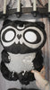 video of a grey and black embroidered moon raccoon plush toy