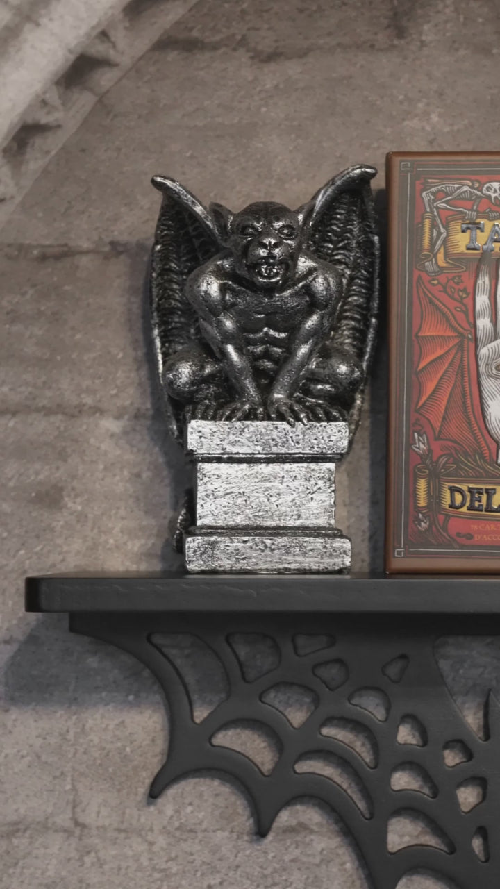 video of a spiderweb bat-shapd wall shelf