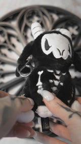 video of a creepy cute skeleton goat plushie keychain