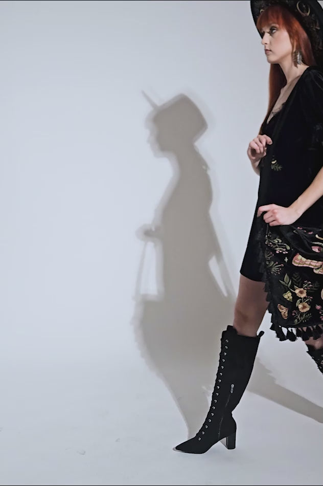 video of gothic witch wearing a large boho goth bag