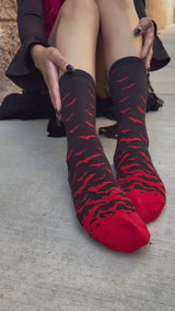gothic woman wearing halloween vampire black and red bat socks
