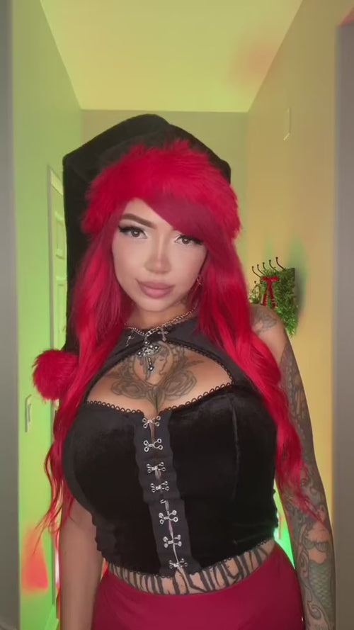 goth women wearing a emo santa clause hat