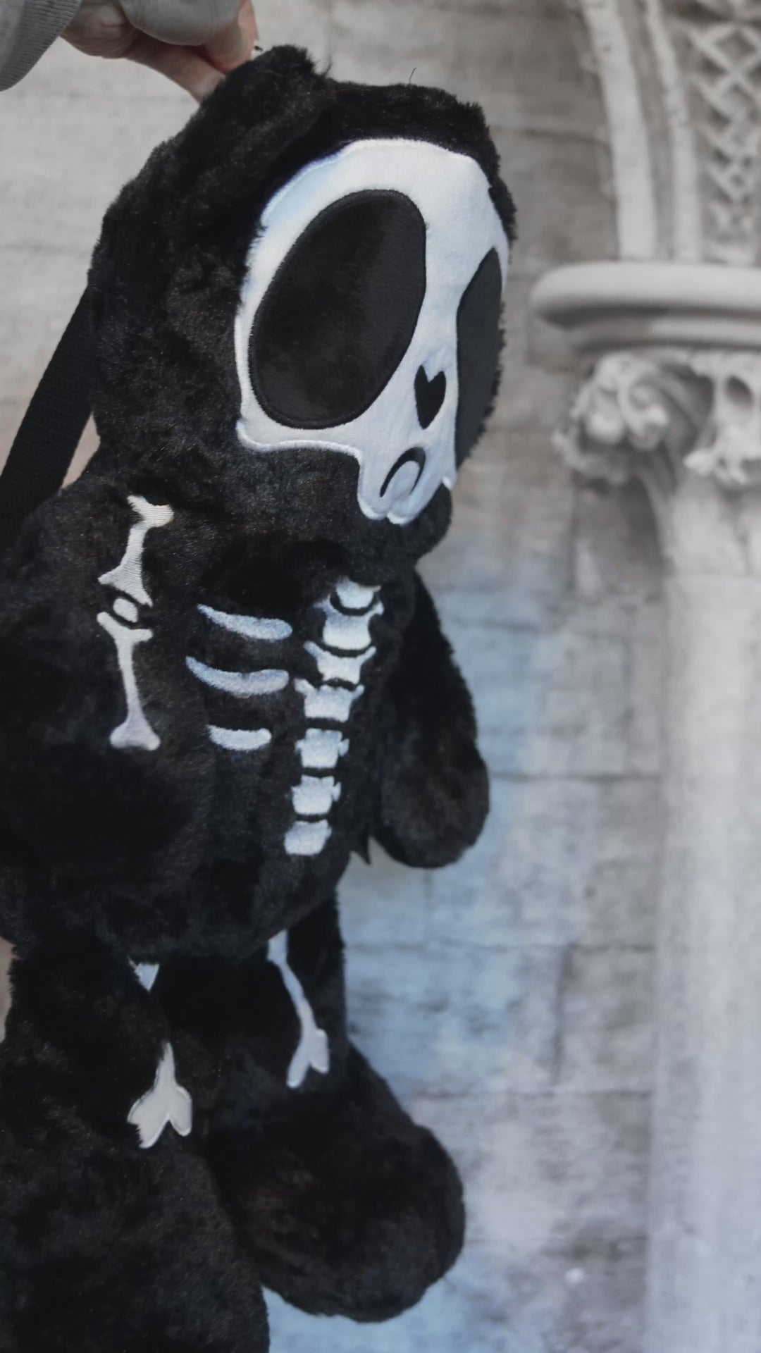 video of a spooky skeleton teddy bear plushie stuffed animal backpack