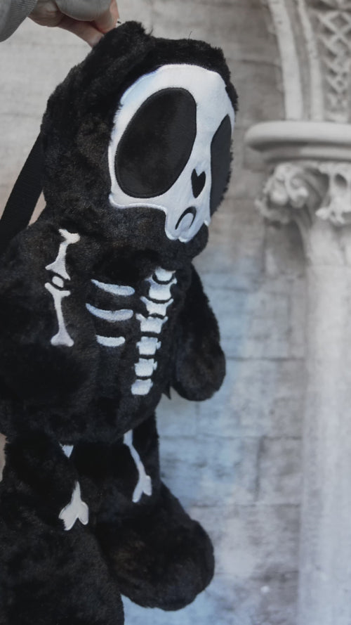video of a spooky skeleton teddy bear plushie stuffed animal backpack