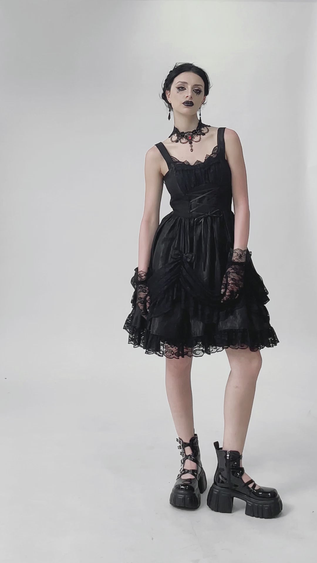 gothic woman wearing a black gothic lolita bow dress