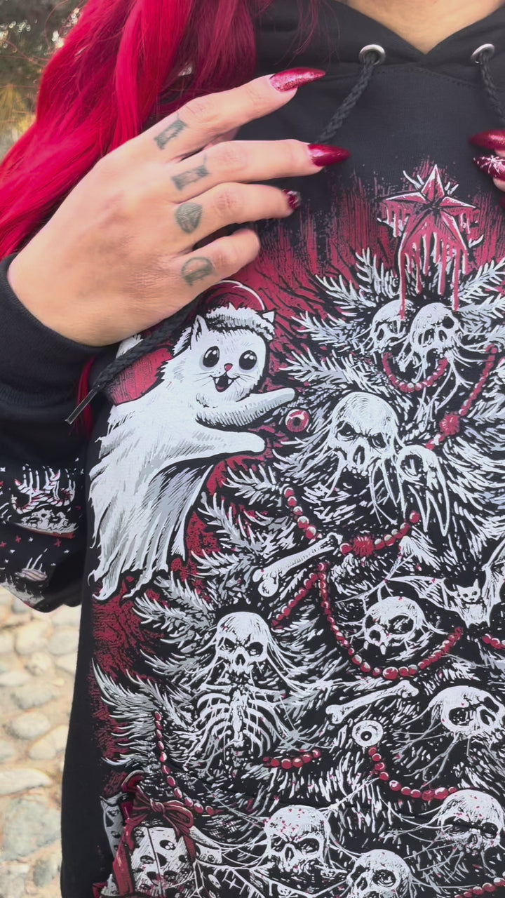 video of an emo girl with red hair wearing a goth xmas hoodie