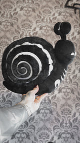 video of a skeleton snail plushie