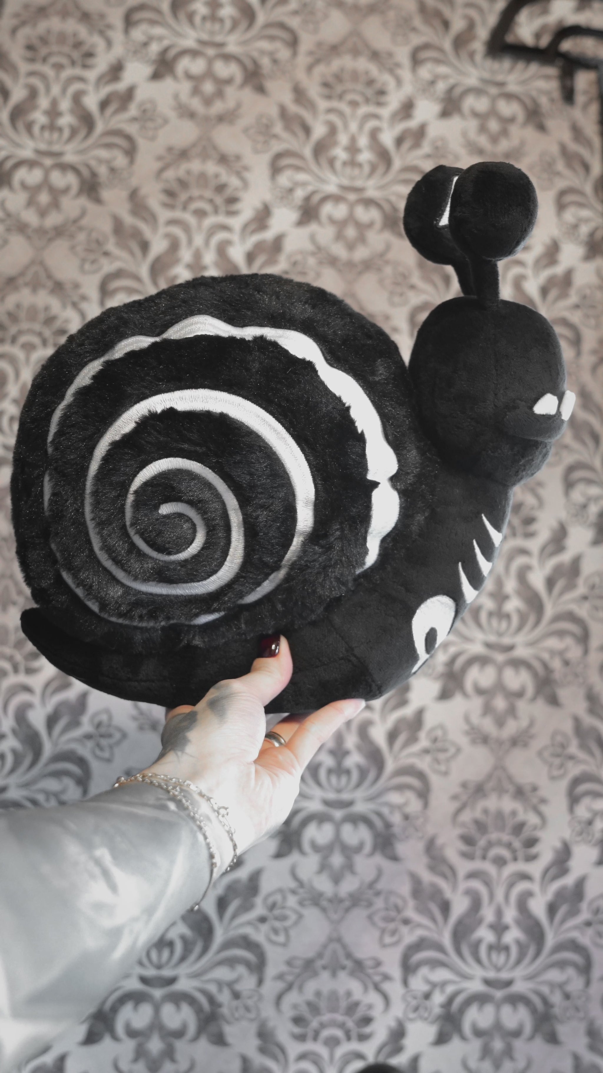 video of a skeleton snail plushie