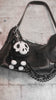 video of a stuffed animal black and white skeleton pig keychain