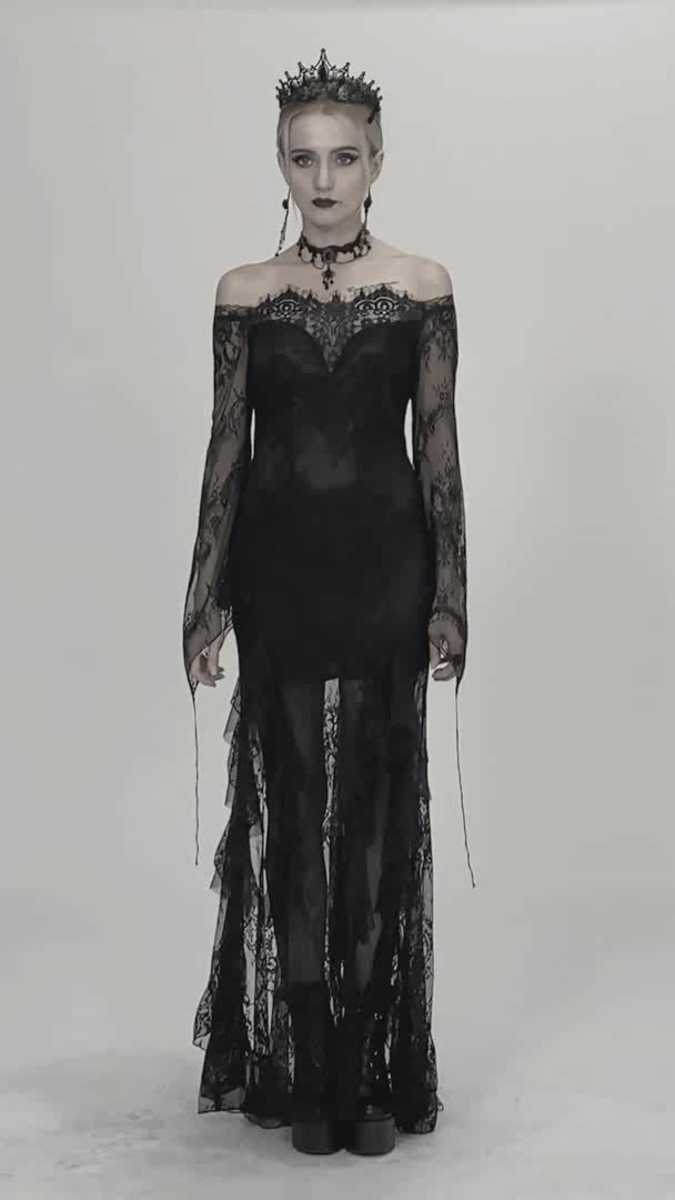 video showing model wearing long gothic black dress with flared sleeves and lace overlay