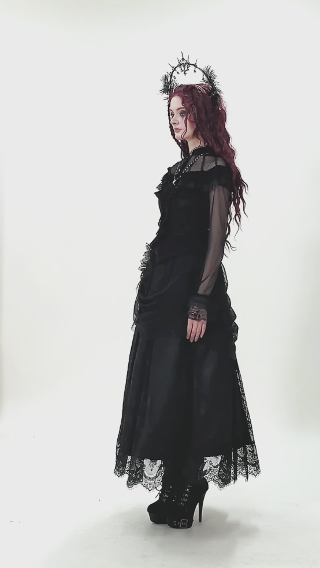 video of a victorian goth woman wearing a ruffled long sleeve top