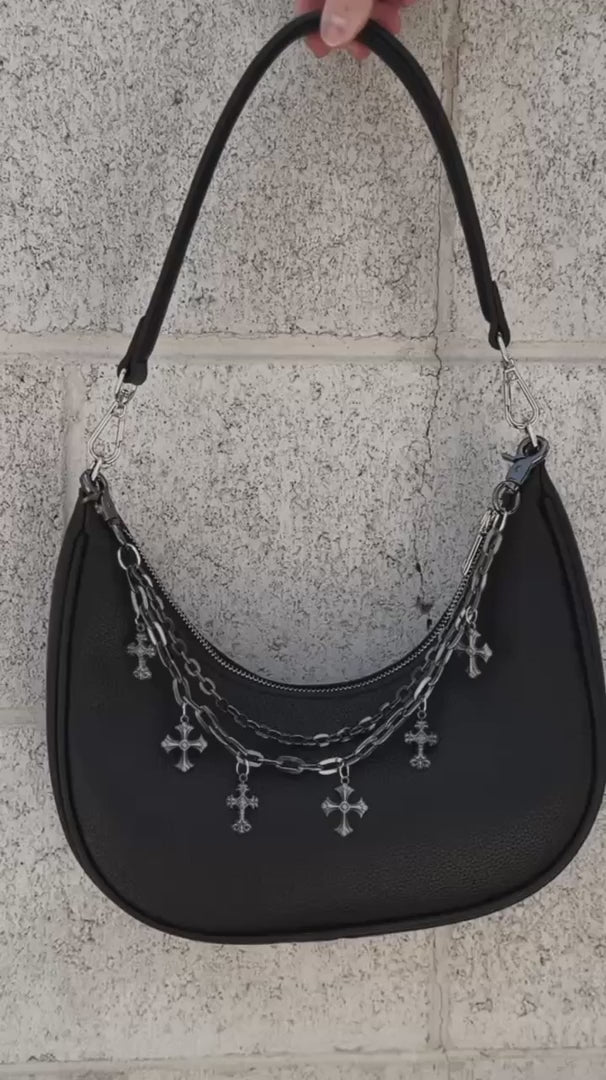 video of a gothic black handbag with a chain strap with charms 