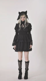 Video of model wearing black puff sleeve dress with lace details