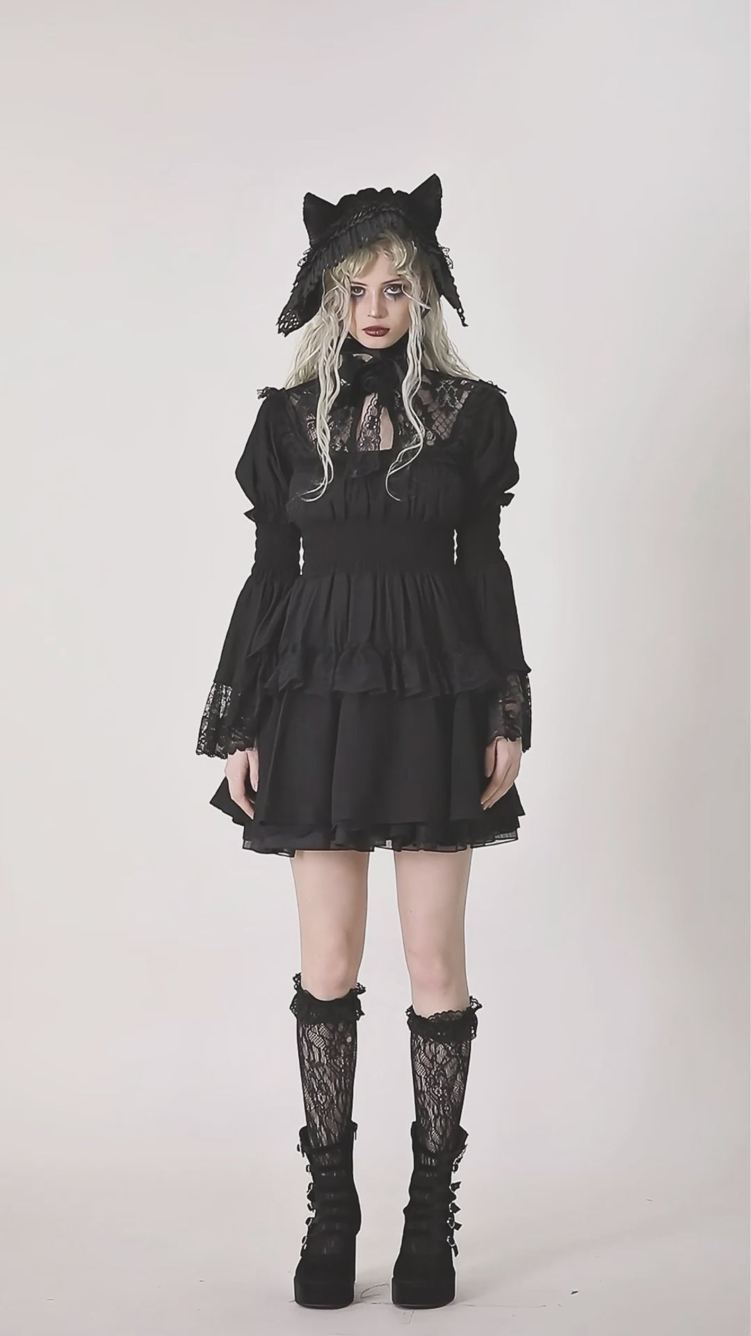 Video of model wearing black puff sleeve dress with lace details
