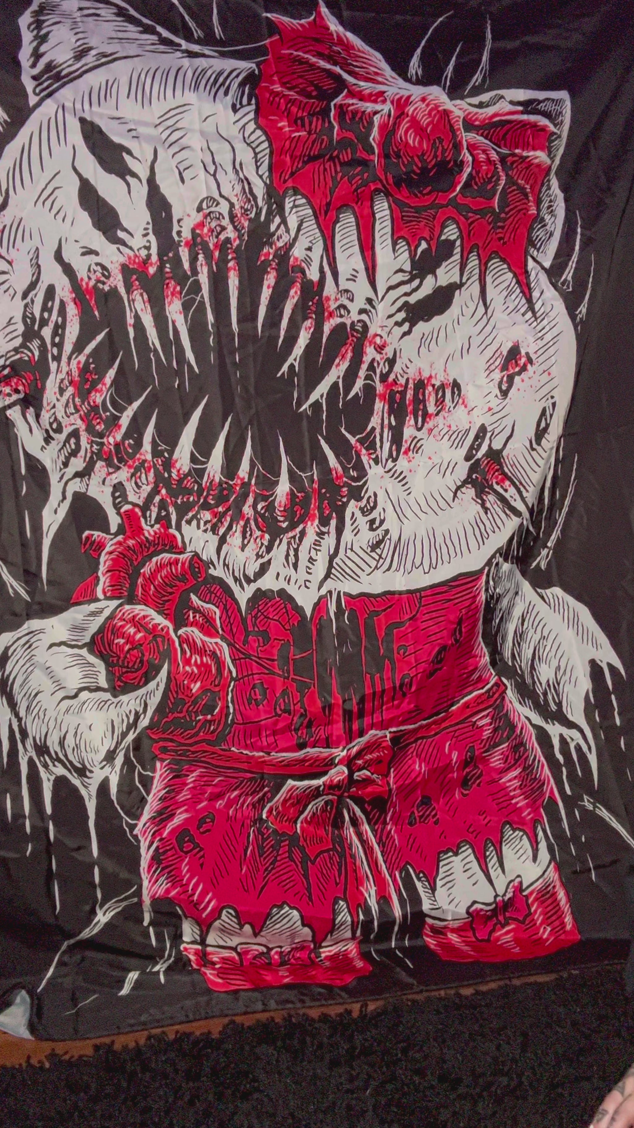 scene woman with pink hair showing off a raven pin made of enamel