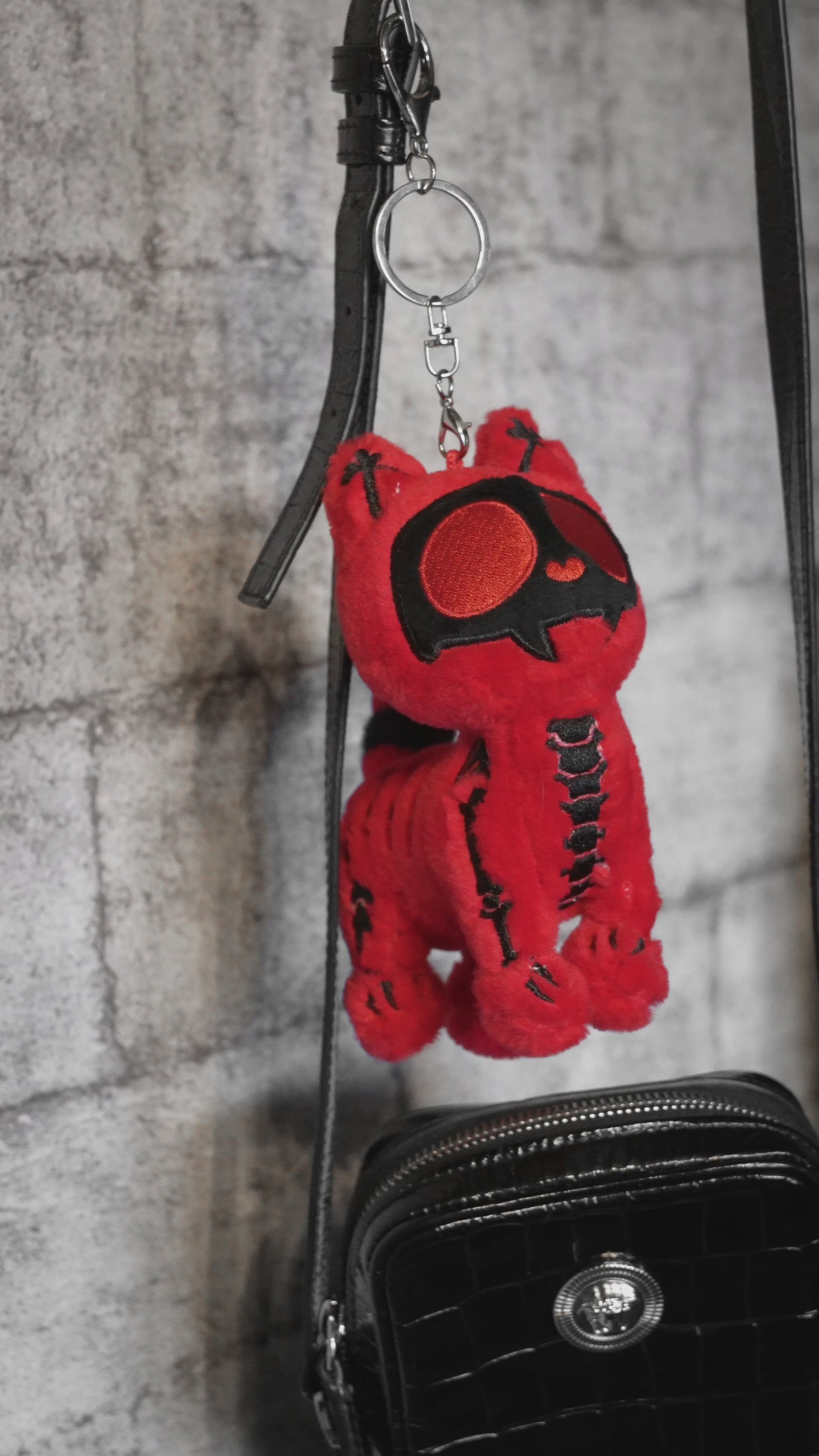 video of a red skeleton cat plushie keychain