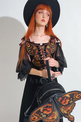 gothic woman wearing a novelty moth backpack