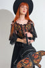 gothic woman wearing a novelty moth backpack