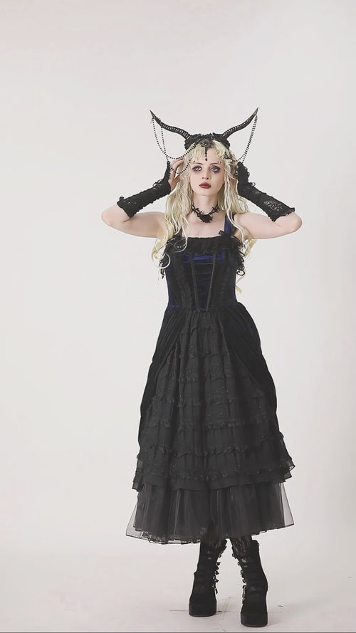 gothic girl wearing black and blue lolita dress