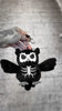 video of a skeleton owl keychain