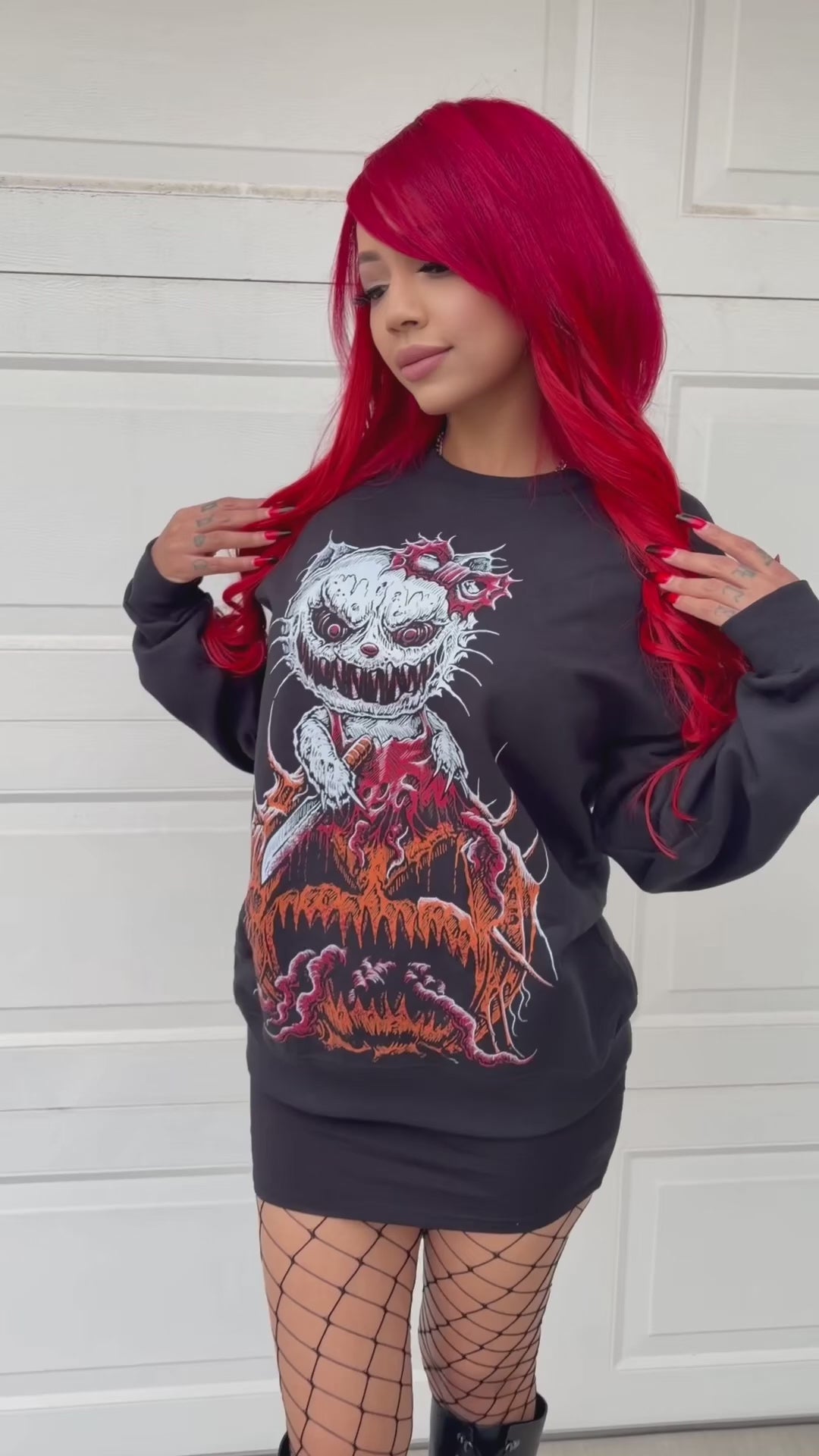 video of a gothic woman with red hair wearing a gothic cat pumpkin horror halloween sweatshirt