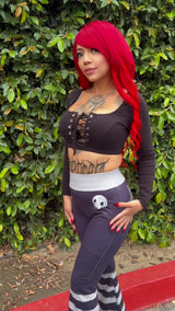 emo woman with red hair wearing creepy cute striped flared pants