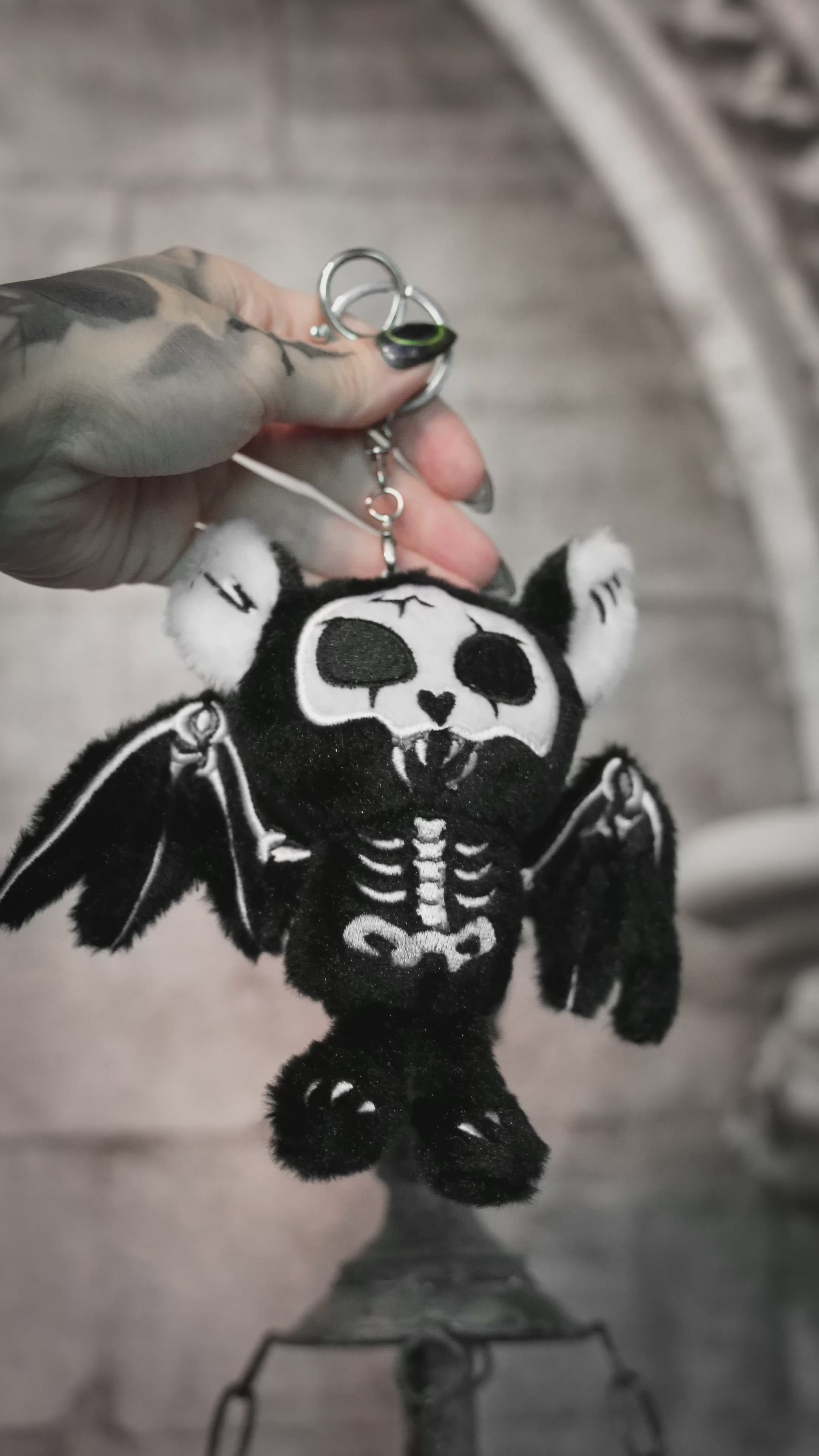 video of a creepy cute skeleton bat plushie keychain bag charm