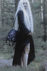 video of a gothic woman wearing a embroidered magical luna moth  bag