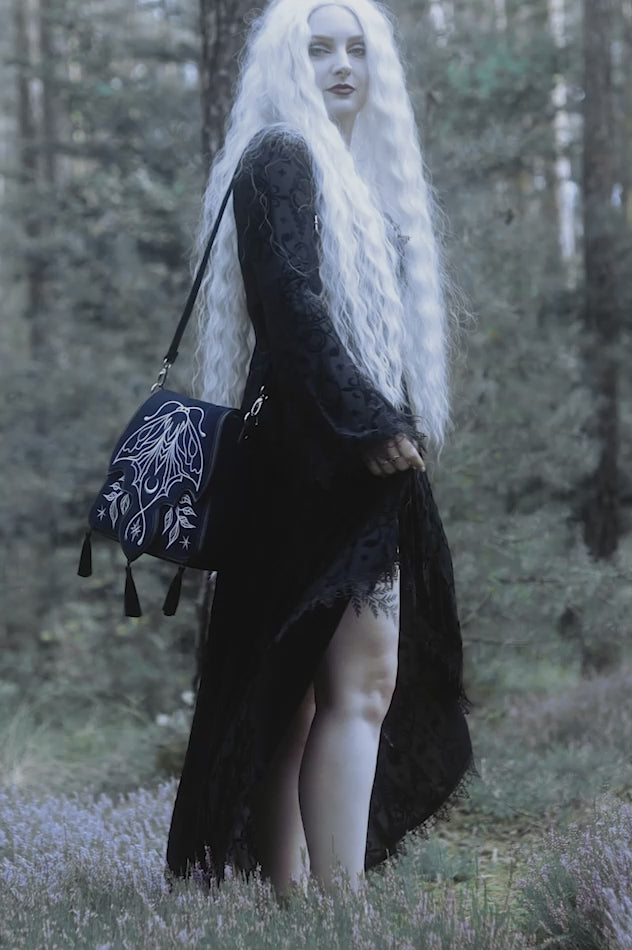 video of a gothic woman wearing a embroidered magical luna moth  bag