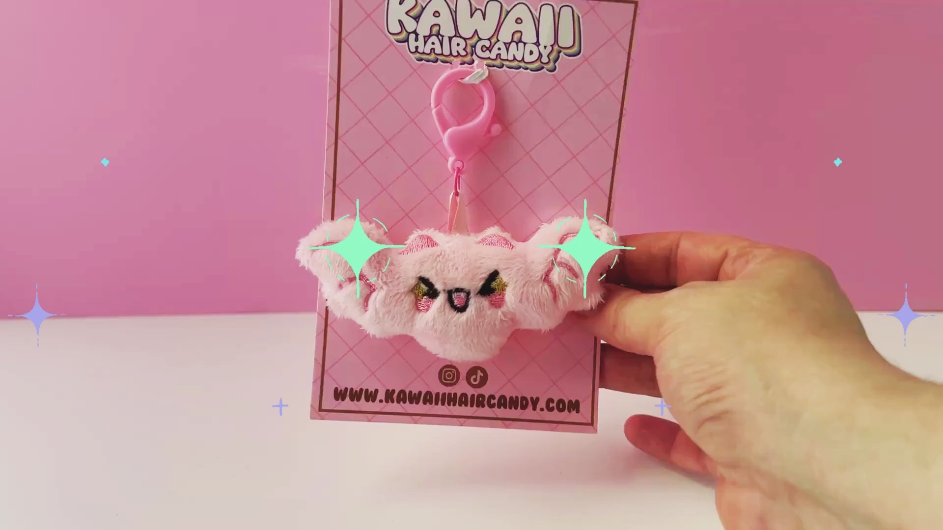 video of an embroidered pink kawaii plushie bat keychain