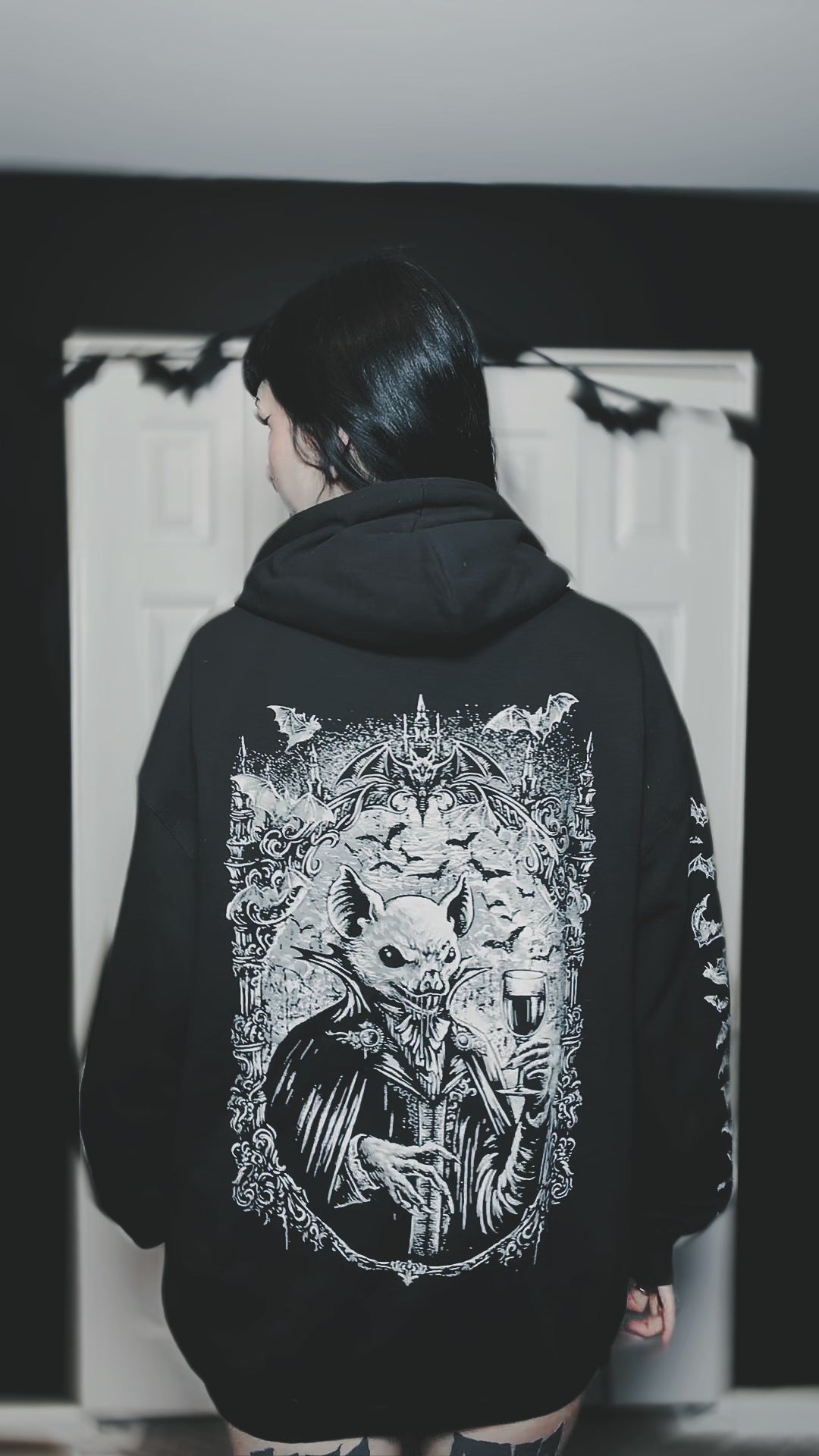 gothic woman wearing a vampire bat hoodie jacket