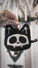 video of a small creepy cute skeleton cat bag charm for cash and coins