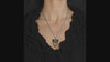 video of a gothic woman wearing a spooky gothic snake necklace with red crystals 
