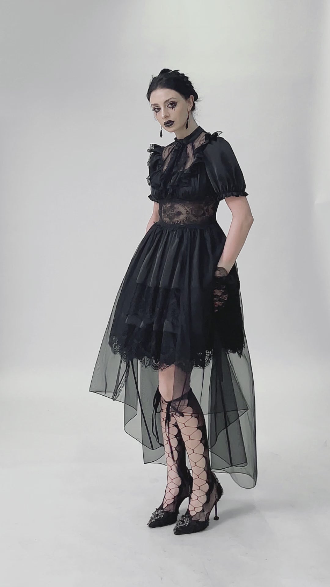 video of a gothic woman wearing a victorian dress with a mesh skirt overlay