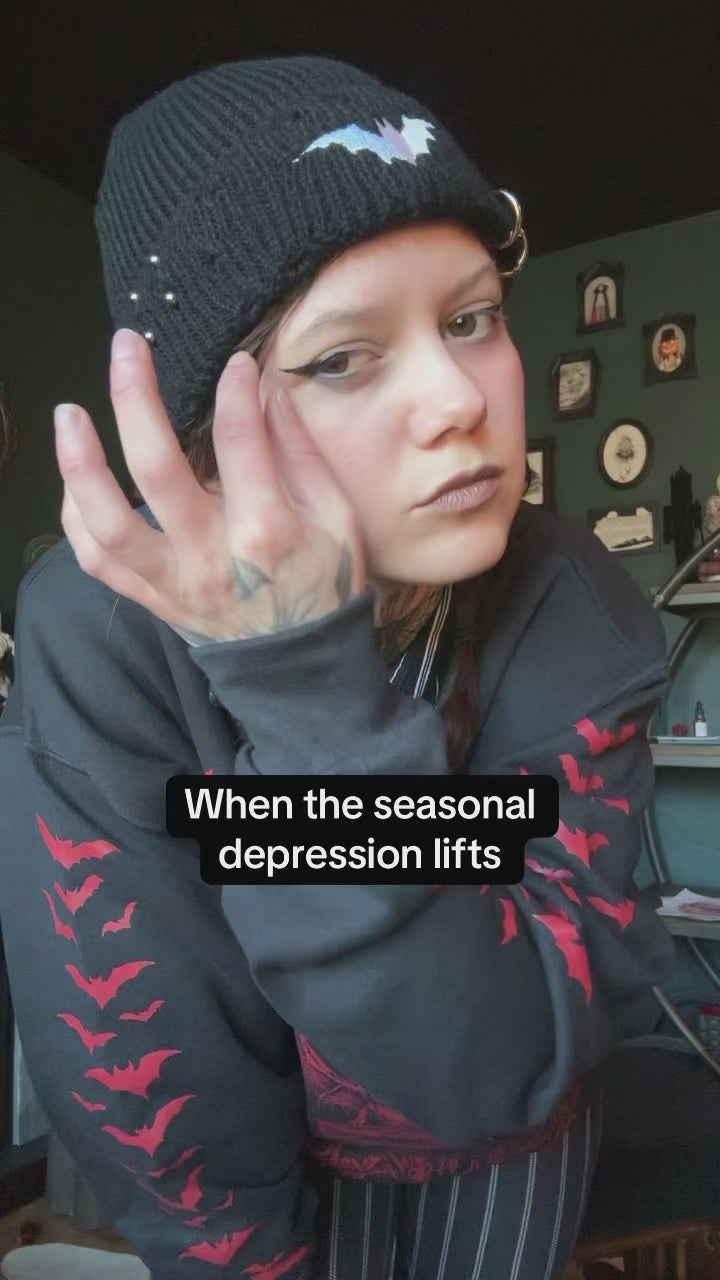 video of tattooed girl wearing bat sweatshirt and skull cap punk beanie