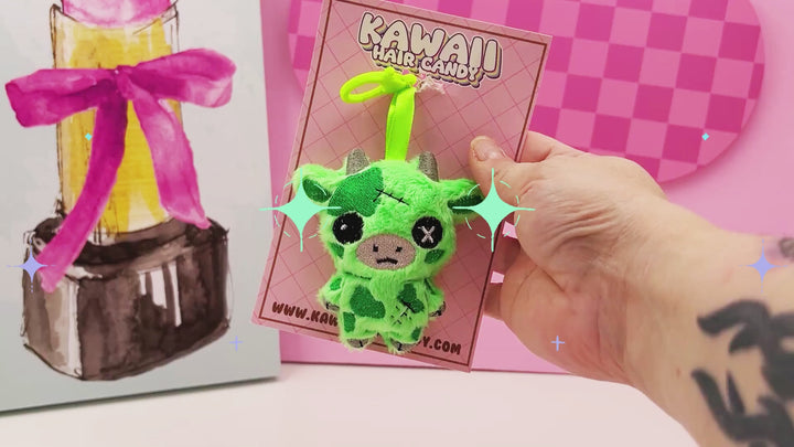 video of a creepy cute zombie plush cow keychain