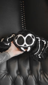 video of a gothic spider skeleton plushie