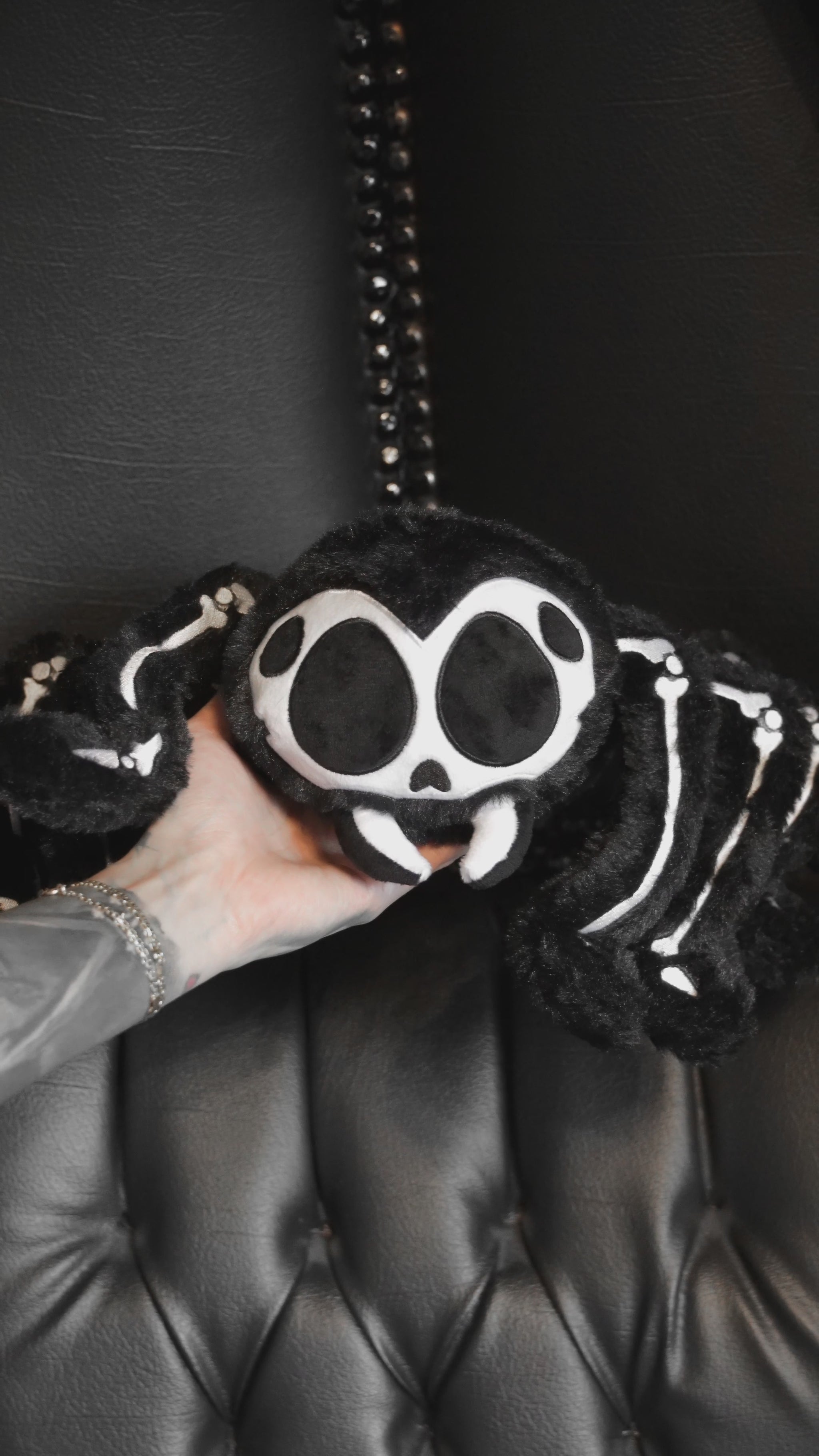 video of a gothic spider skeleton plushie