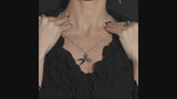 video of a gothic woman wearing a whimsical dark gothic horror scissors necklace