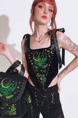 video of a gothic woman wearing a forest goth nature lover corset with embroidered ferns 