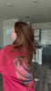 Video of woman wearing black tank top with Medusa graphic on front