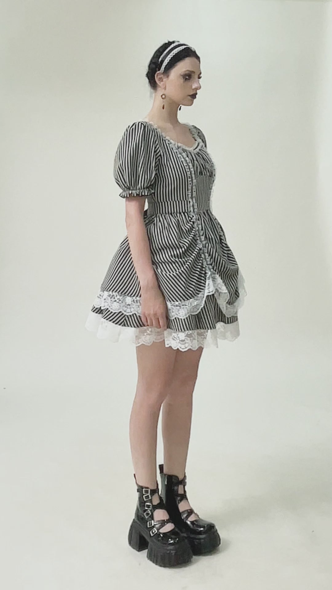 video of a woman wearing a womens striped layered puff sleeve mini dress by dark in love