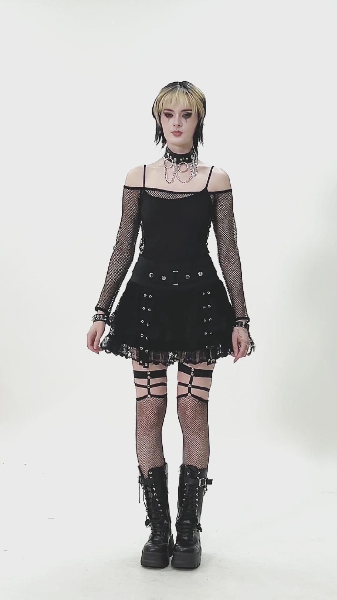 emo woman wearing a off the shoulder fishnet shirt