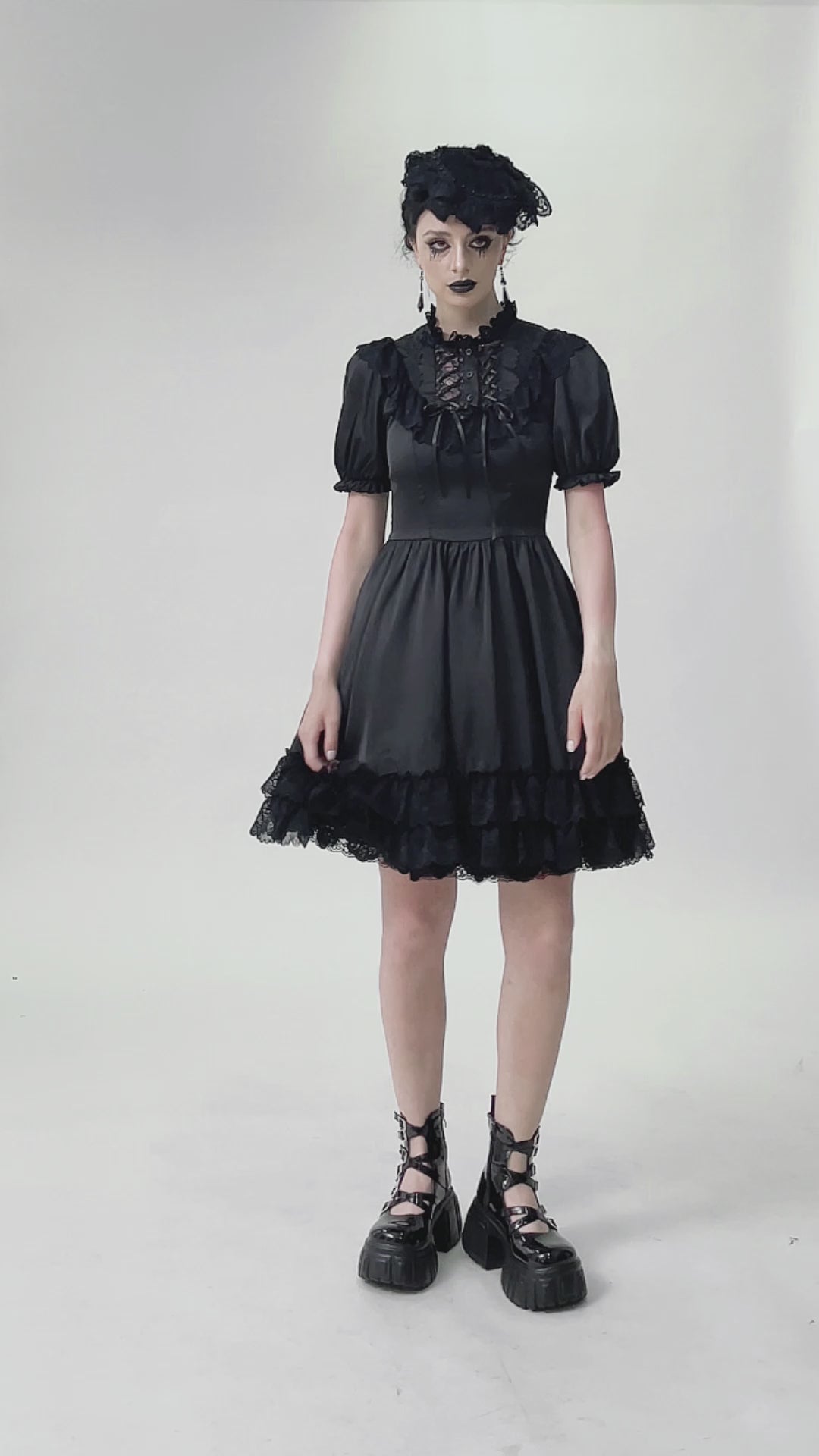 video of a gothic girl wearing a dark lolita flared skirt dress