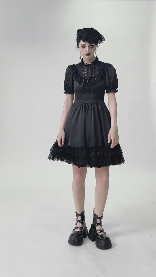 video of a gothic girl wearing a dark lolita flared skirt dress