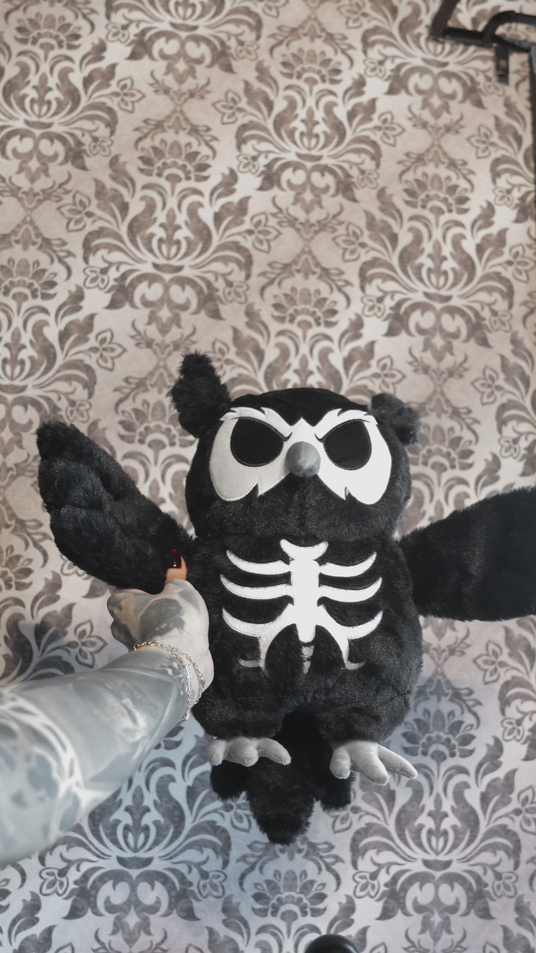 video of a skeleton owl plushie