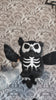 video of a skeleton owl plushie