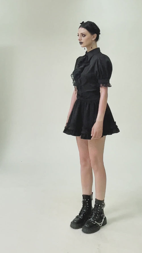 video of a gothic girl wearing a pointed collar puffed short sleeve shirt