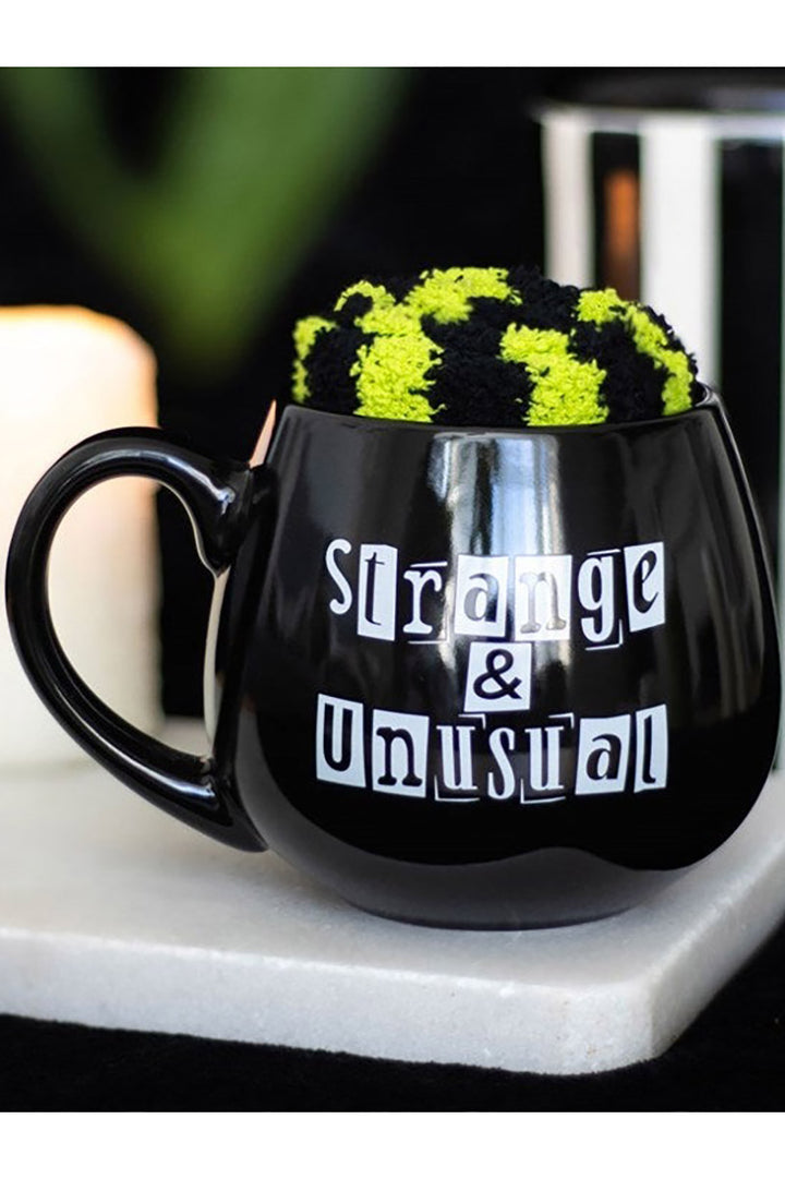 spooky mug with striped goth socks